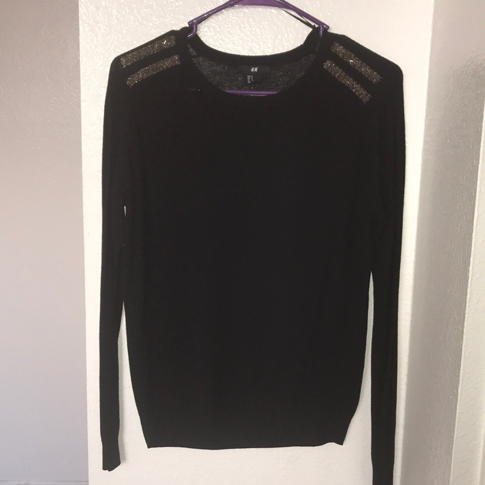 Black shoulder beaded sweater .